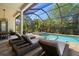 Screened-in pool and spa with covered patio and lounge chairs at 8434 Dunham Station Dr, Tampa, FL 33647