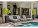 Inviting pool deck with three lounge chairs and a view into the home's interior at 8434 Dunham Station Dr, Tampa, FL 33647