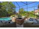 Screened-in pool with fire pit and outdoor seating at 8434 Dunham Station Dr, Tampa, FL 33647