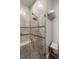 Tiled shower with dual shower head, a built in bench and glass door in the bathroom at 8434 Dunham Station Dr, Tampa, FL 33647