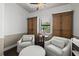 Comfortable sitting area featuring two armchairs and custom wood cabinets at 8434 Dunham Station Dr, Tampa, FL 33647