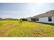 Expansive backyard with lush green grass and a view of neighboring homes at 8529 Regal Ln, Hudson, FL 34667