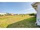 Lush backyard with expansive lawn and serene neighborhood views in the distance at 8529 Regal Ln, Hudson, FL 34667