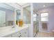 Bathroom featuring a vanity mirror, glass shower, and natural lighting at 8529 Regal Ln, Hudson, FL 34667