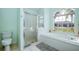 Bright bathroom featuring a large tub under a window and glass enclosed shower at 8529 Regal Ln, Hudson, FL 34667