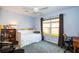 Cozy bedroom with large window, desk and chair, and colorful decorations at 8529 Regal Ln, Hudson, FL 34667