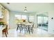 Sunny breakfast nook with views of the outdoors, a table and chairs, and tile floors at 8529 Regal Ln, Hudson, FL 34667