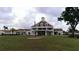 Elegant clubhouse featuring a classic architectural style and manicured front lawn at 8529 Regal Ln, Hudson, FL 34667