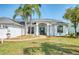Inviting single-story home with arched entry, well-kept lawn and sidewalk, radiating classic charm at 8529 Regal Ln, Hudson, FL 34667