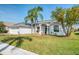 Charming home with a well-manicured lawn, mature trees, and an inviting two-car garage at 8529 Regal Ln, Hudson, FL 34667