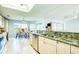 Bright kitchen with light cabinetry, granite countertops, and an open view of the dining and living areas at 8529 Regal Ln, Hudson, FL 34667