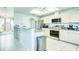 Bright kitchen featuring stainless steel appliances, tile floors, and a sunlit skylight at 8529 Regal Ln, Hudson, FL 34667