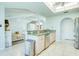 Open kitchen view with granite countertops, modern appliances, and seamless flow to the living area at 8529 Regal Ln, Hudson, FL 34667