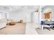 Bright living room features a ceiling fan and blends carpeted and tiled sections in a neutral color palette at 8529 Regal Ln, Hudson, FL 34667