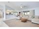 Open-concept living room with a view of the kitchen, neutral tones, and a comfortable sectional sofa at 8529 Regal Ln, Hudson, FL 34667