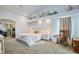 Cozy main bedroom with neutral tones, plush carpet, and a decorative shelf at 8529 Regal Ln, Hudson, FL 34667