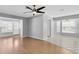 Open living room featuring wood-look floors, tile floors, ceiling fan, and neutral paint at 9529 Bunker Hill Ct, New Port Richey, FL 34655