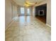 Open living room with tile floor, fireplace, ceiling fan and window at 977 Gershwin Dr, Largo, FL 33771
