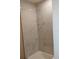 Bathroom featuring a tiled tub surround with decorative faux stone at 10116 N Highland Ave, Tampa, FL 33612