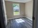 Cozy bedroom with fresh paint and new floors, looking out into a private backyard at 10116 N Highland Ave, Tampa, FL 33612