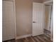 Neutral bedroom showcasing fresh paint, new flooring, and white trim, with closet and ensuite access at 10116 N Highland Ave, Tampa, FL 33612