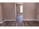Bedroom with wood floor, fresh paint, and view to a bathroom at 10116 N Highland Ave, Tampa, FL 33612