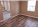 Neutral bedroom showcasing fresh paint, new flooring, and white trim, with closet and ensuite access at 10116 N Highland Ave, Tampa, FL 33612