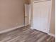 Bedroom with closet, fresh paint, and wood floors at 10116 N Highland Ave, Tampa, FL 33612