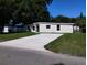 Charming one-story home with a freshly painted exterior and a well-manicured lawn at 10116 N Highland Ave, Tampa, FL 33612
