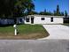 Charming one-story home with a freshly painted exterior and a well-manicured lawn at 10116 N Highland Ave, Tampa, FL 33612