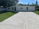 Charming single-story home with a well-manicured lawn and a spacious concrete driveway at 10116 N Highland Ave, Tampa, FL 33612