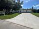 Charming single-story home with a well-manicured lawn and a spacious concrete driveway at 10116 N Highland Ave, Tampa, FL 33612