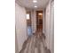 Bright hallway featuring new floors and doors leading to rooms at 10116 N Highland Ave, Tampa, FL 33612