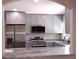 Modern kitchen featuring stainless steel appliances, gray cabinets, and granite countertops at 10116 N Highland Ave, Tampa, FL 33612