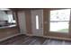 Inviting living area with natural light, wood flooring, and open access to kitchen at 10116 N Highland Ave, Tampa, FL 33612