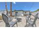 Cozy backyard featuring a fire pit with chairs, and a dining table, ideal for relaxing and entertaining guests at 110 8Th St, Belleair Beach, FL 33786