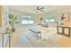 Serene bedroom with neutral tones, two windows, a ceiling fan, and a stylish accent rug at 110 8Th St, Belleair Beach, FL 33786