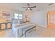 Tranquil bedroom features a ceiling fan, two windows providing natural light, and a comfortable upholstered bench at 110 8Th St, Belleair Beach, FL 33786
