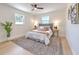 Cozy bedroom with two windows, a ceiling fan, and a decorative rug at 110 8Th St, Belleair Beach, FL 33786