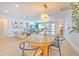 Open-concept design featuring a dining area seamlessly connected to living and kitchen spaces at 110 8Th St, Belleair Beach, FL 33786