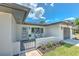 Inviting front porch with seating and a well-maintained garden, perfect for enjoying sunny days at 110 8Th St, Belleair Beach, FL 33786