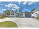 Charming single-story home with a well-manicured lawn and a spacious concrete driveway at 110 8Th St, Belleair Beach, FL 33786