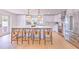 Bright, modern kitchen features white cabinets, stainless steel appliances, a large island with seating, and stylish pendant lighting at 110 8Th St, Belleair Beach, FL 33786