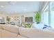 Bright living room featuring comfortable seating, a large window, and modern decor at 110 8Th St, Belleair Beach, FL 33786