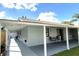 Back of the home with a covered patio including chairs and a small table at 11303 Hollyglen Dr, Tampa, FL 33624
