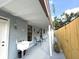 Covered rear porch with tile flooring and a sink; great for entertaining or relaxing outdoors at 11303 Hollyglen Dr, Tampa, FL 33624