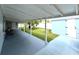Rear porch with a table and chairs, and a nice view of the backyard and shed at 11303 Hollyglen Dr, Tampa, FL 33624