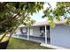 View of the back of the home, including a covered patio and seating area at 11303 Hollyglen Dr, Tampa, FL 33624