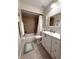 Bathroom with a shower-tub combination, white vanity, and neutral tile at 11303 Hollyglen Dr, Tampa, FL 33624
