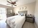 Cozy bedroom with neutral tones, decorative accents, ceiling fan and natural light at 11303 Hollyglen Dr, Tampa, FL 33624
